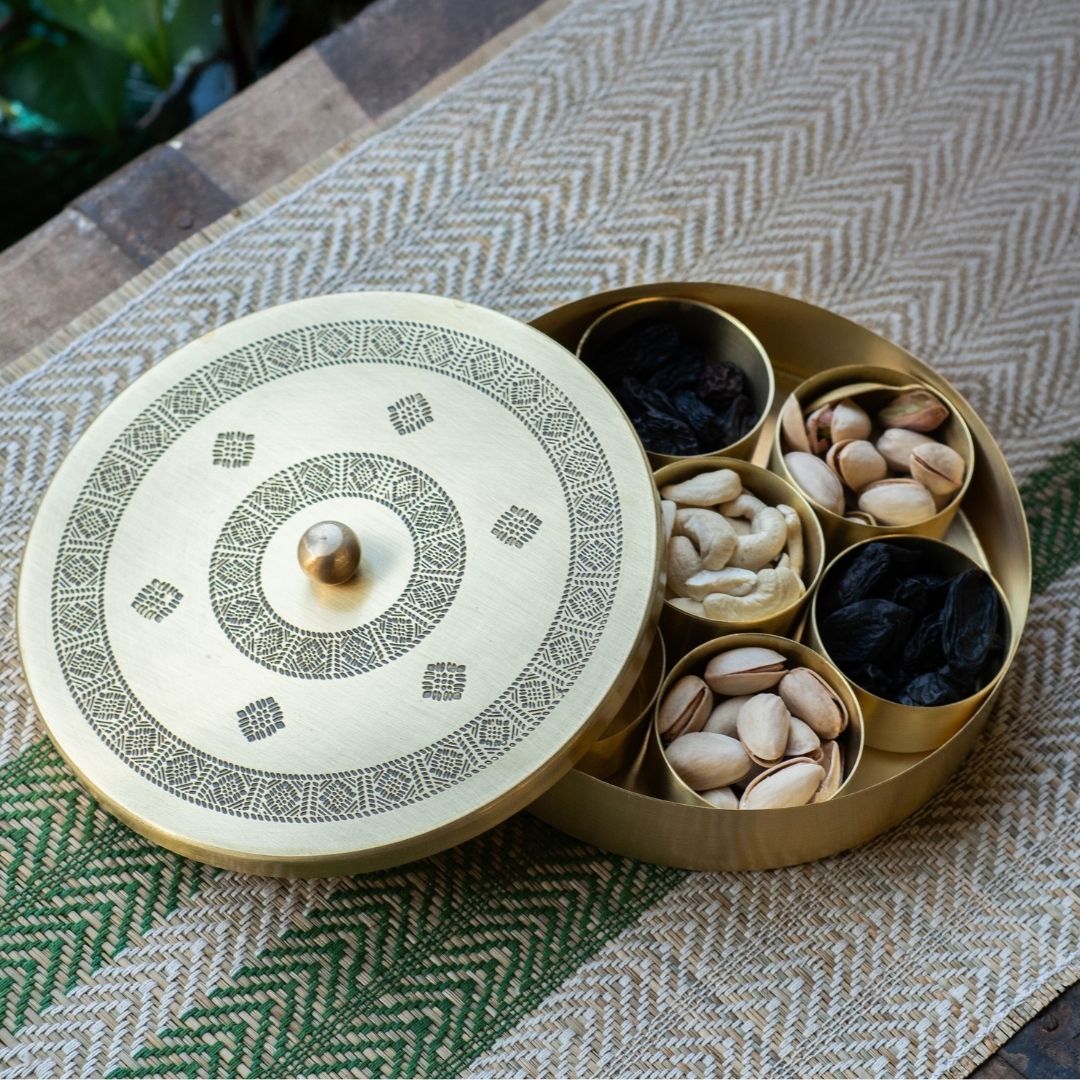 Handcrafted pure brass kitchen masala box with Kanjeevaram-inspired etching, adding timeless Indian elegance.