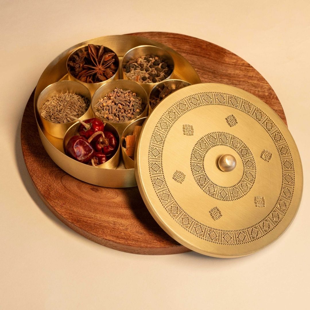 Handcrafted pure brass kitchen masala box with Kanjeevaram-inspired etching, adding timeless Indian elegance.