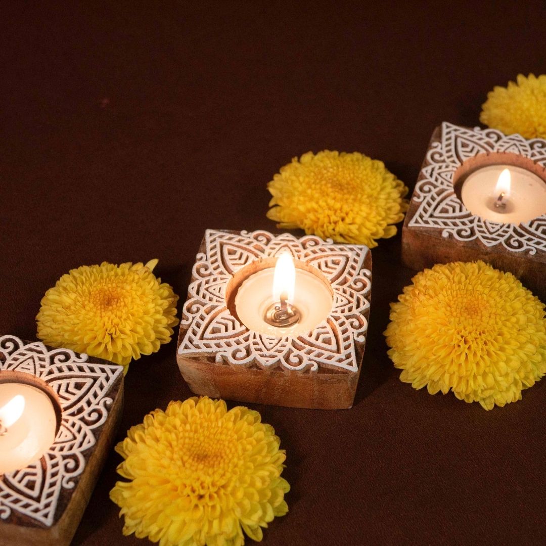 Hand-engraved mango wood diya set with tea lights in white and brown, set of 4, ideal for festive home décor and gifting.