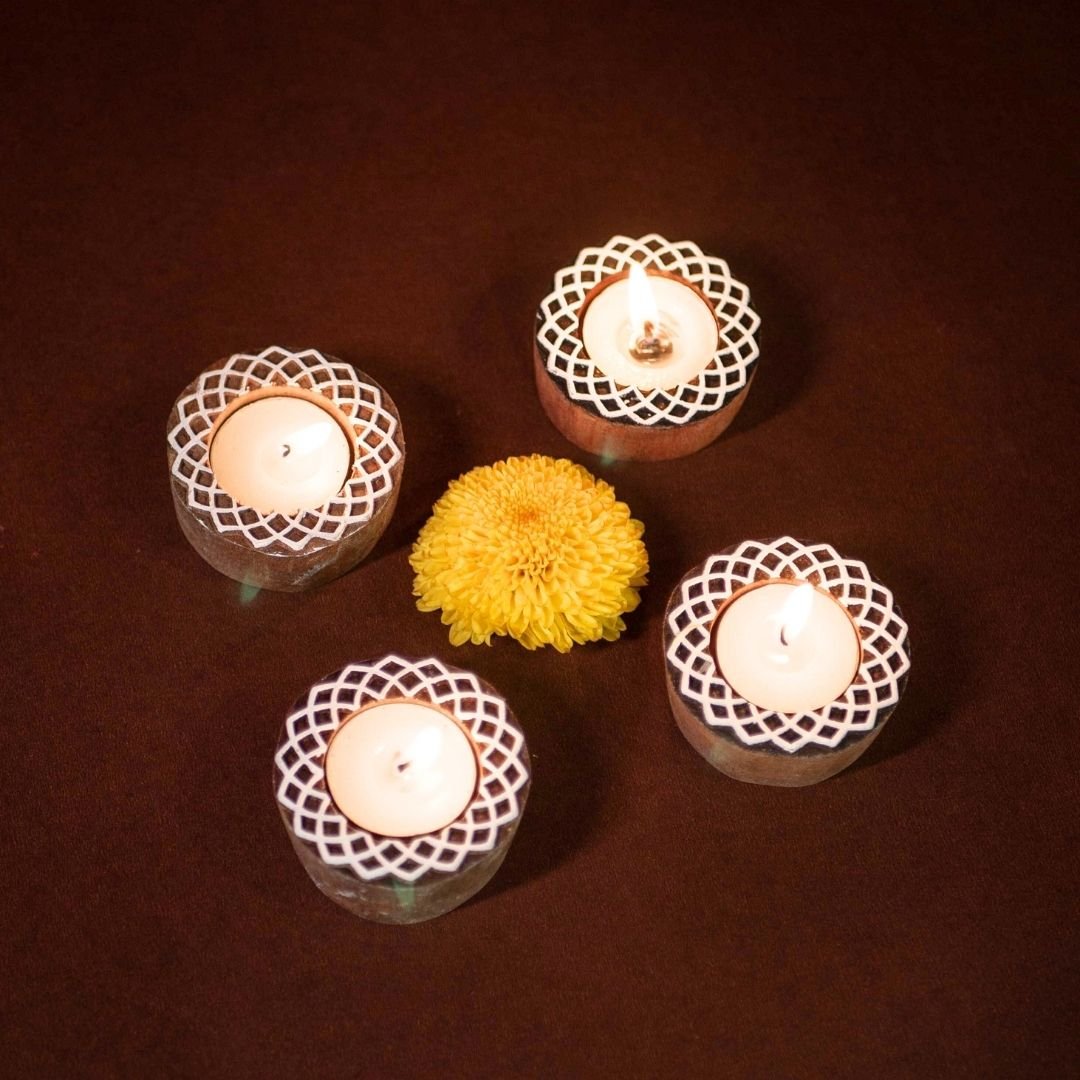 Hand-engraved mango wood diya set with tea lights in white and brown, set of 4, ideal for festive home décor and gifting.