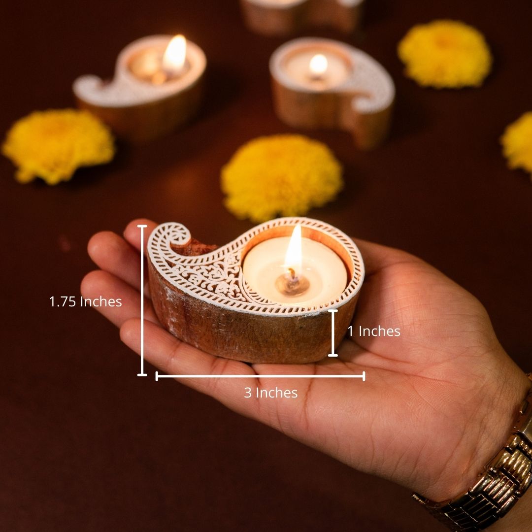 Hand-engraved mango wood diya set with tea lights in white and brown, set of 4, ideal for festive home décor and gifting.