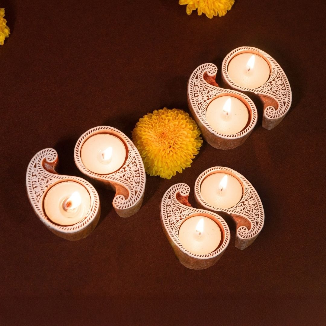 Hand-engraved mango wood diya set with tea lights in white and brown, set of 6, ideal for festive home décor and gifting.