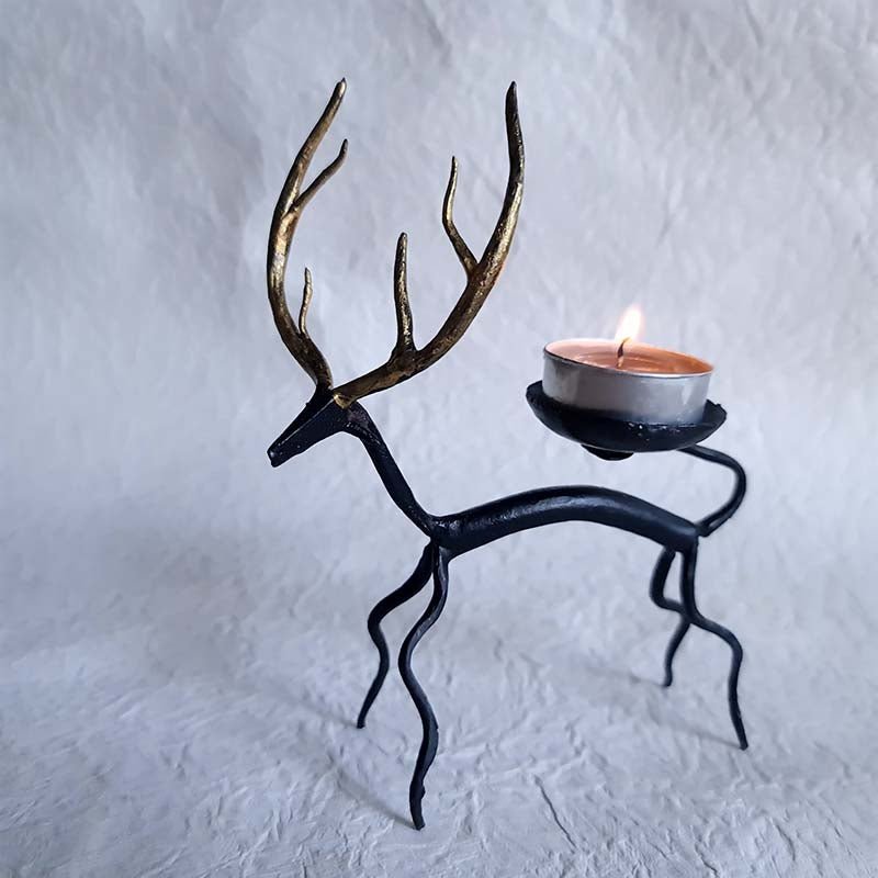 Handcrafted Bastar wrought iron golden deer tealight holders. Set of 2 artisan pieces for warm, elegant home décor.
