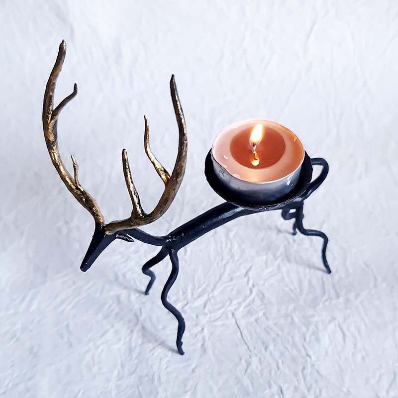 Handcrafted Bastar wrought iron golden deer tealight holders. Set of 2 artisan pieces for warm, elegant home décor.