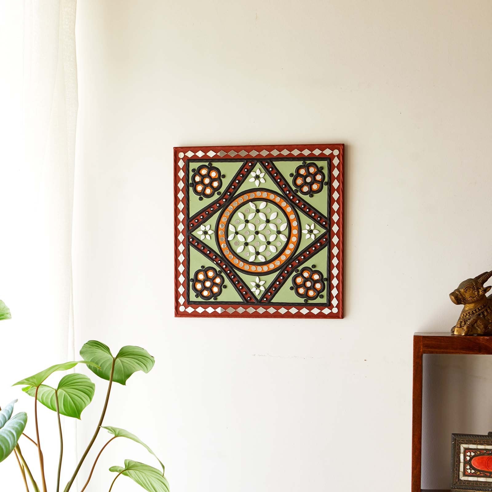 Green patterned handcrafted mud and mirror wall art, adding a rustic and artistic touch