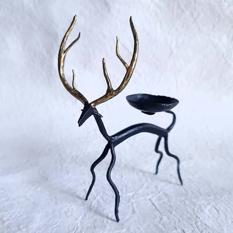 Handcrafted Bastar wrought iron golden deer tealight holders. Set of 2 artisan pieces for warm, elegant home décor.