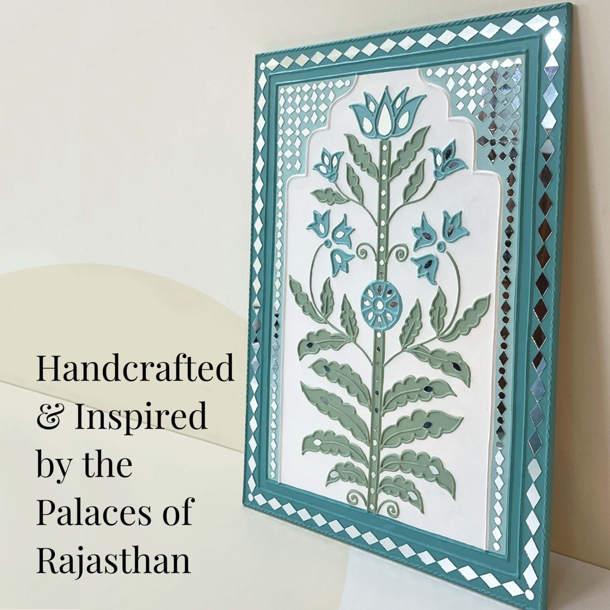 Handmade white & light green lippan wall hanging with mud and mirror work from Kutch.