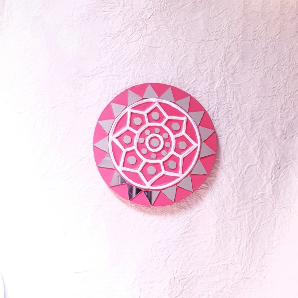 Set of 2 round pink handcrafted mud and mirror work wall art pieces, featuring delicate design