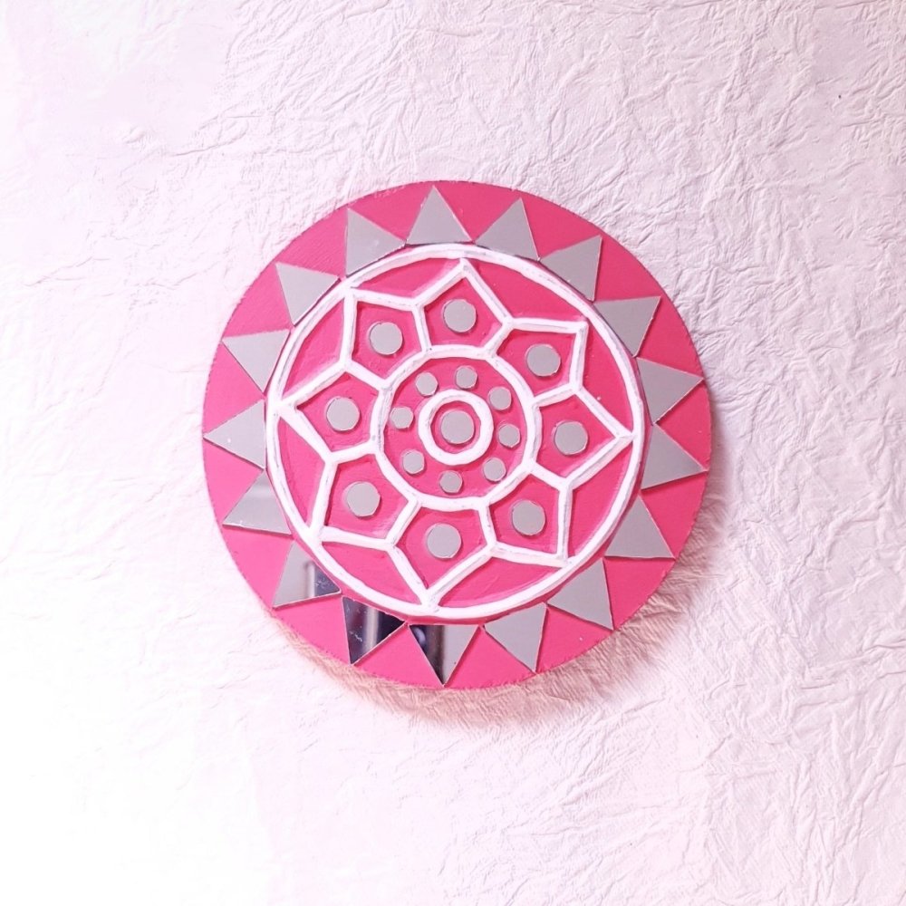 Set of 2 round pink handcrafted mud and mirror work wall art pieces, featuring delicate design