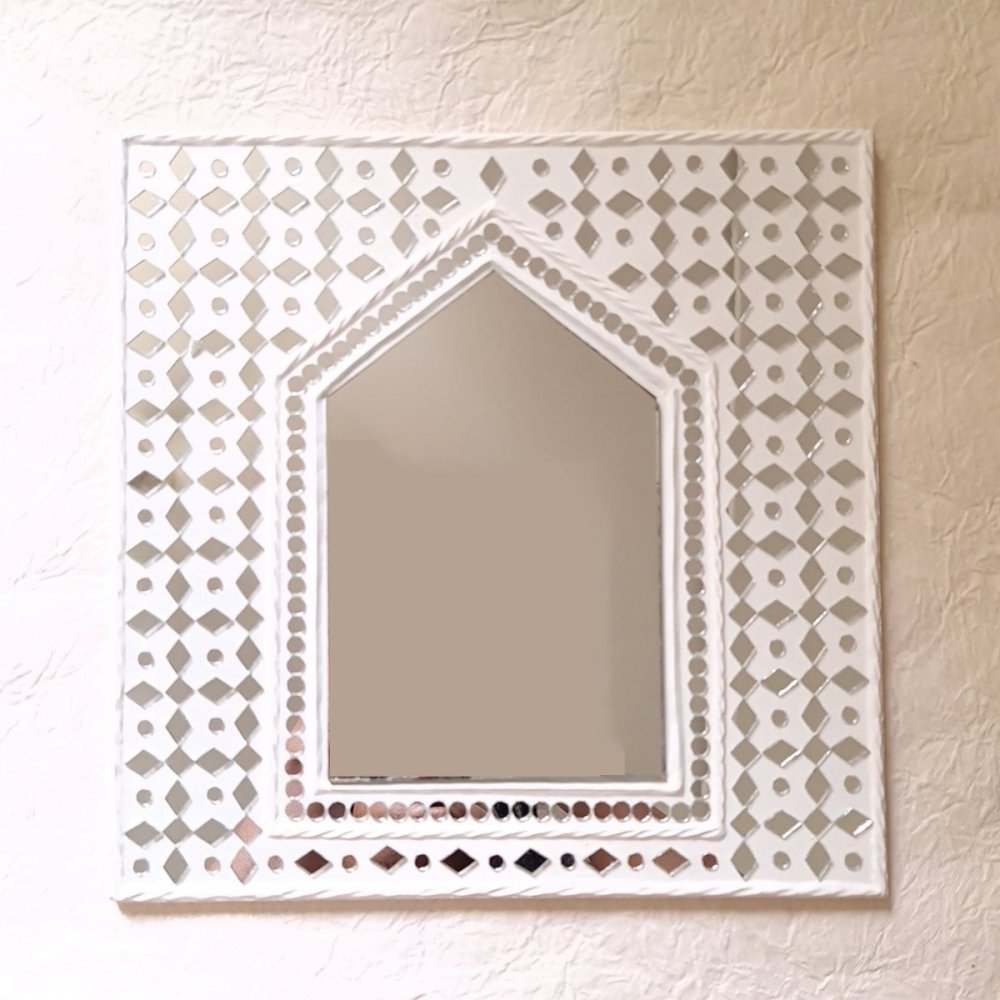 White sparkles hut-inspired mud decor mirror, adding a rustic and elegant touch to your wall