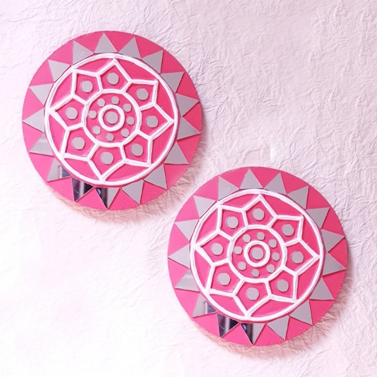 Set of 2 round pink handcrafted mud and mirror work wall art pieces, featuring delicate design