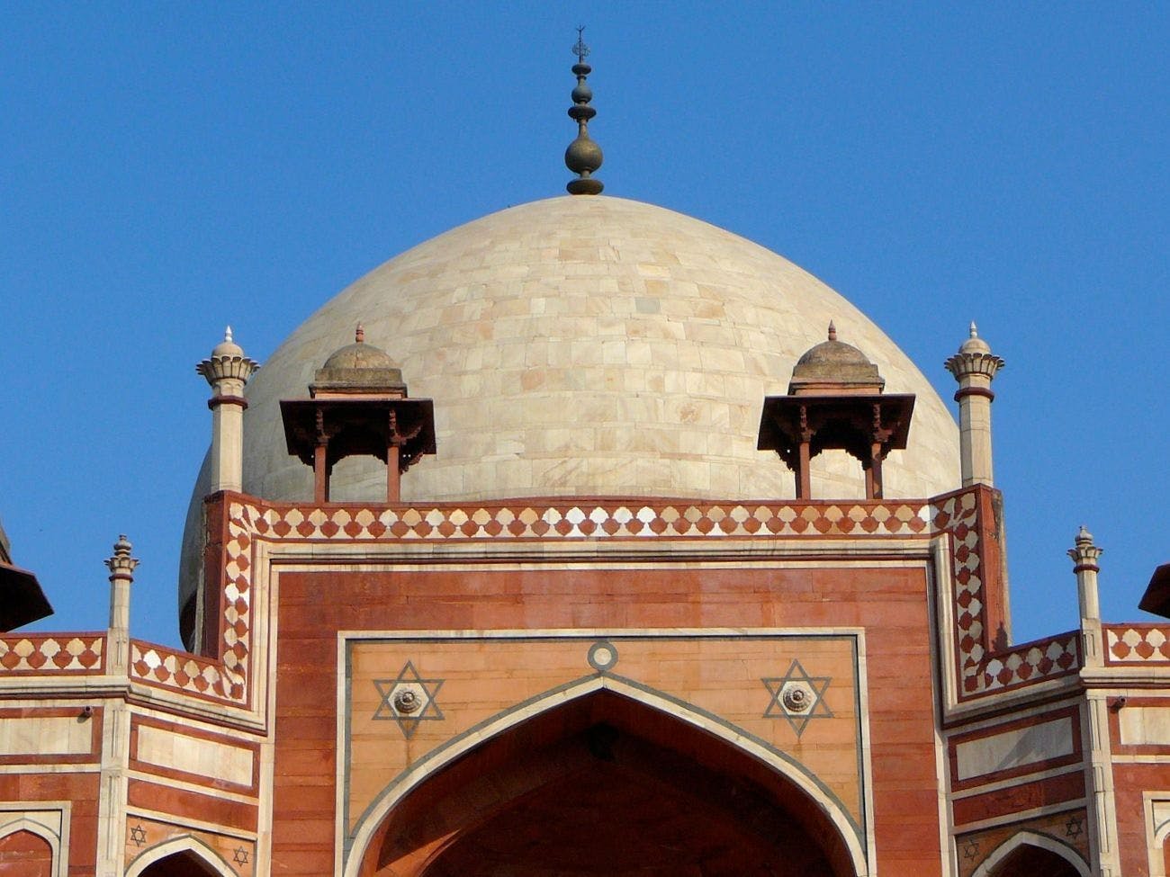 The white marble dome of the tomb with chhatris