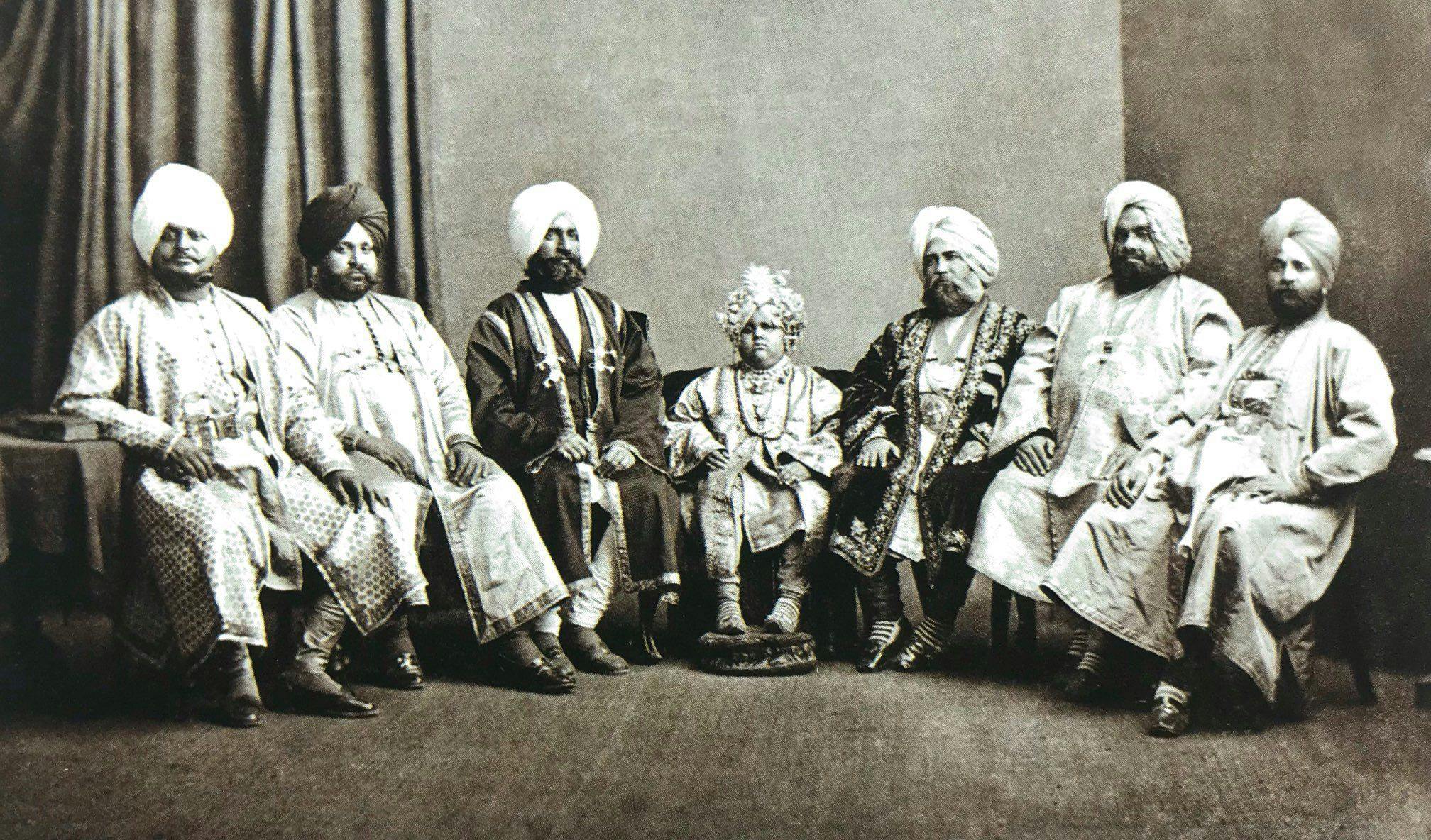 Maharaja, age eight, seated with his senior officials