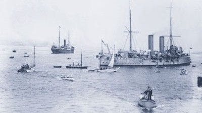 SS Komagata Maru (far left) being escorted out to sea by HMCS Rainbow and tugboats,1914