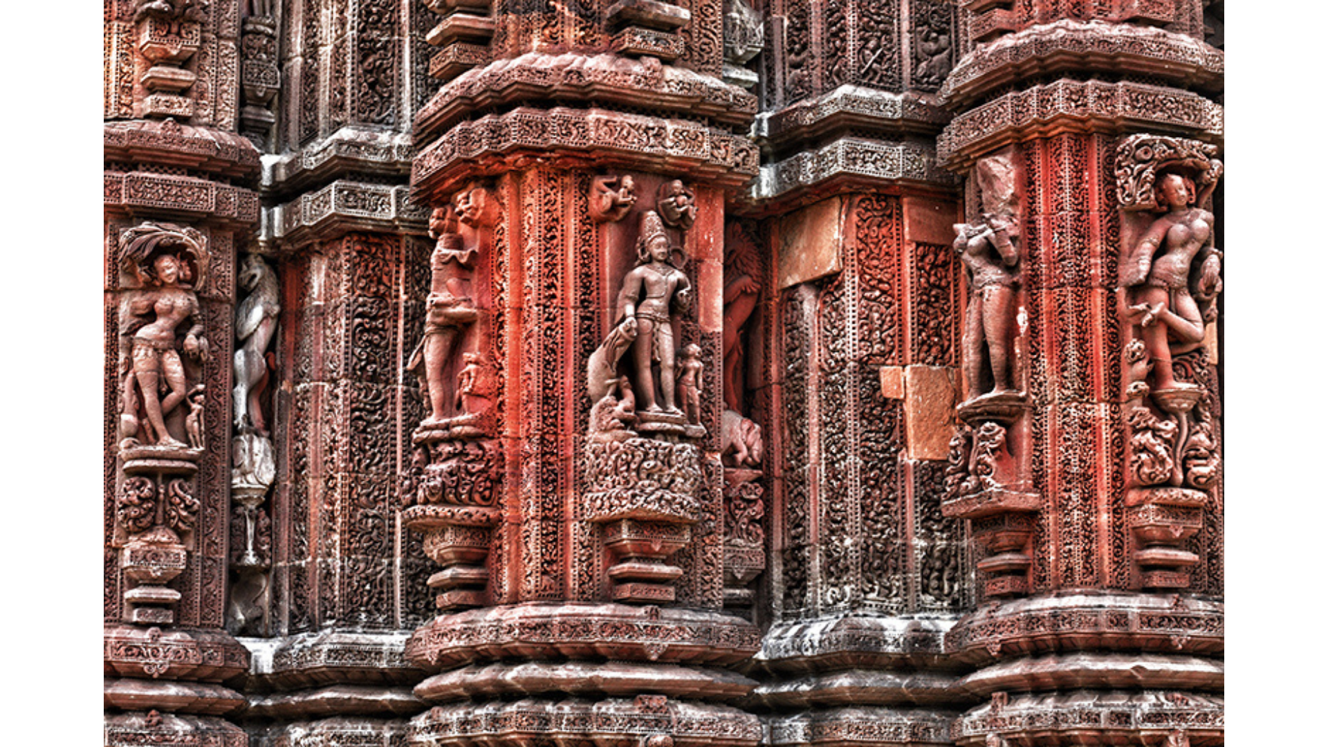 Carvings of Varuna, Lord of the Waters, and other gods, on the temple walls. The female figures in various poses have striking similarities to those found in the Khajuraho temples in Madhya Pradesh.