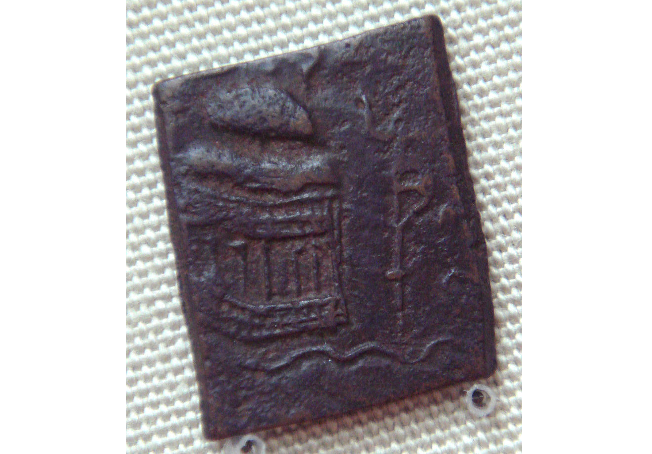 Copper coin of the Audumbaras with temple and trident-battleaxe standard
