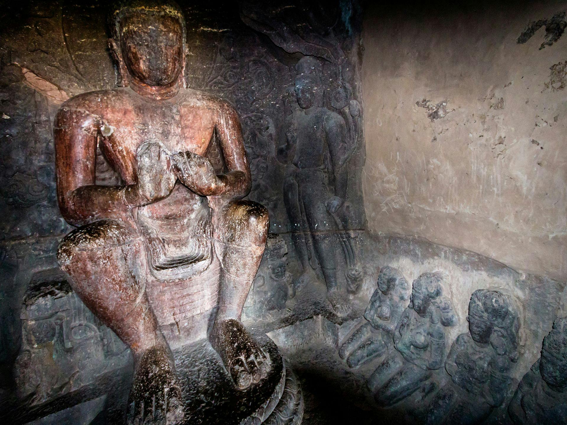 A seated Buddha sculpture in the caves