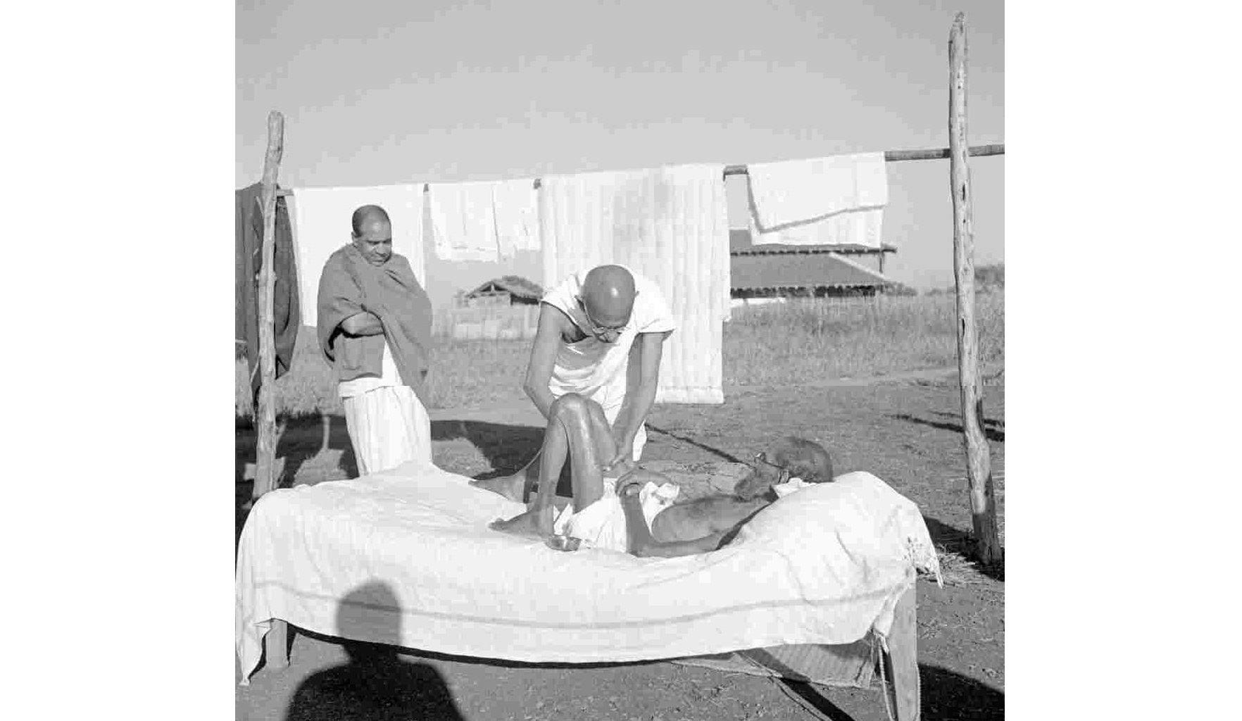 Gandhi giving a massage to Parchure Shastri, 1940