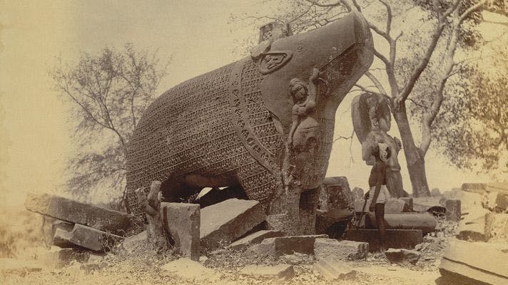 The Eran Varaha boar statue with ruins in late 19th-century, showing the relief on the boar’s body
