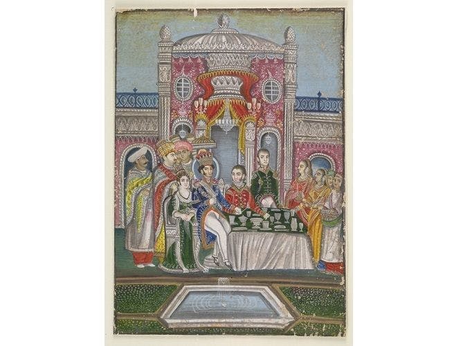 Nawab Nasir al-Din Haidar Shah is seen seated at a table with a British officer on his left and an English lady on his right