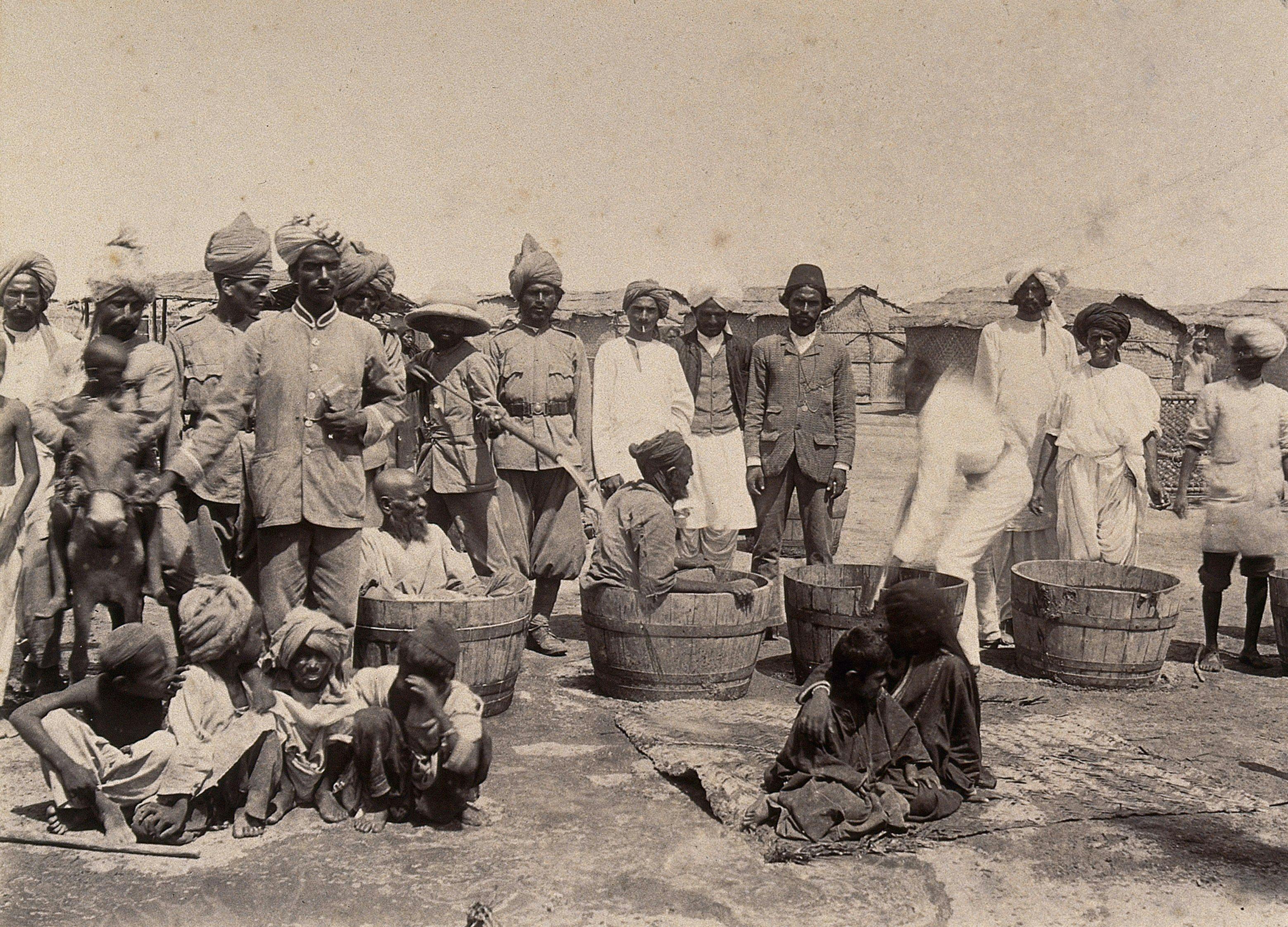Disinfecting sufferers of the plague in wooden tubs, Karachi 