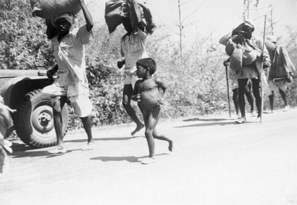 Burmese_refugees_flee_along_the_Prome_Road_into_India,_January_1942