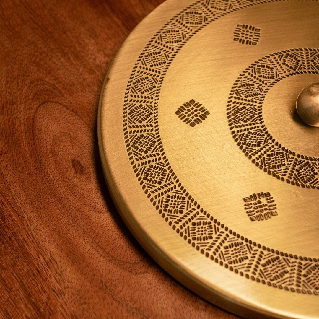 Handcrafted pure brass kitchen masala box with Kanjeevaram-inspired etching, adding timeless Indian elegance.