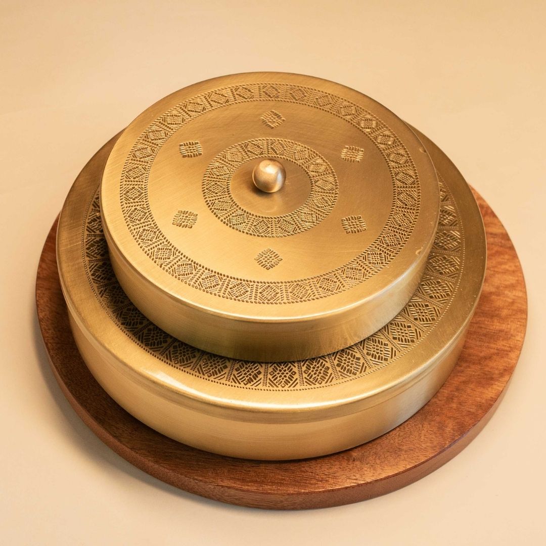 Handcrafted pure brass kitchen masala box with Kanjeevaram-inspired etching, adding timeless Indian elegance.