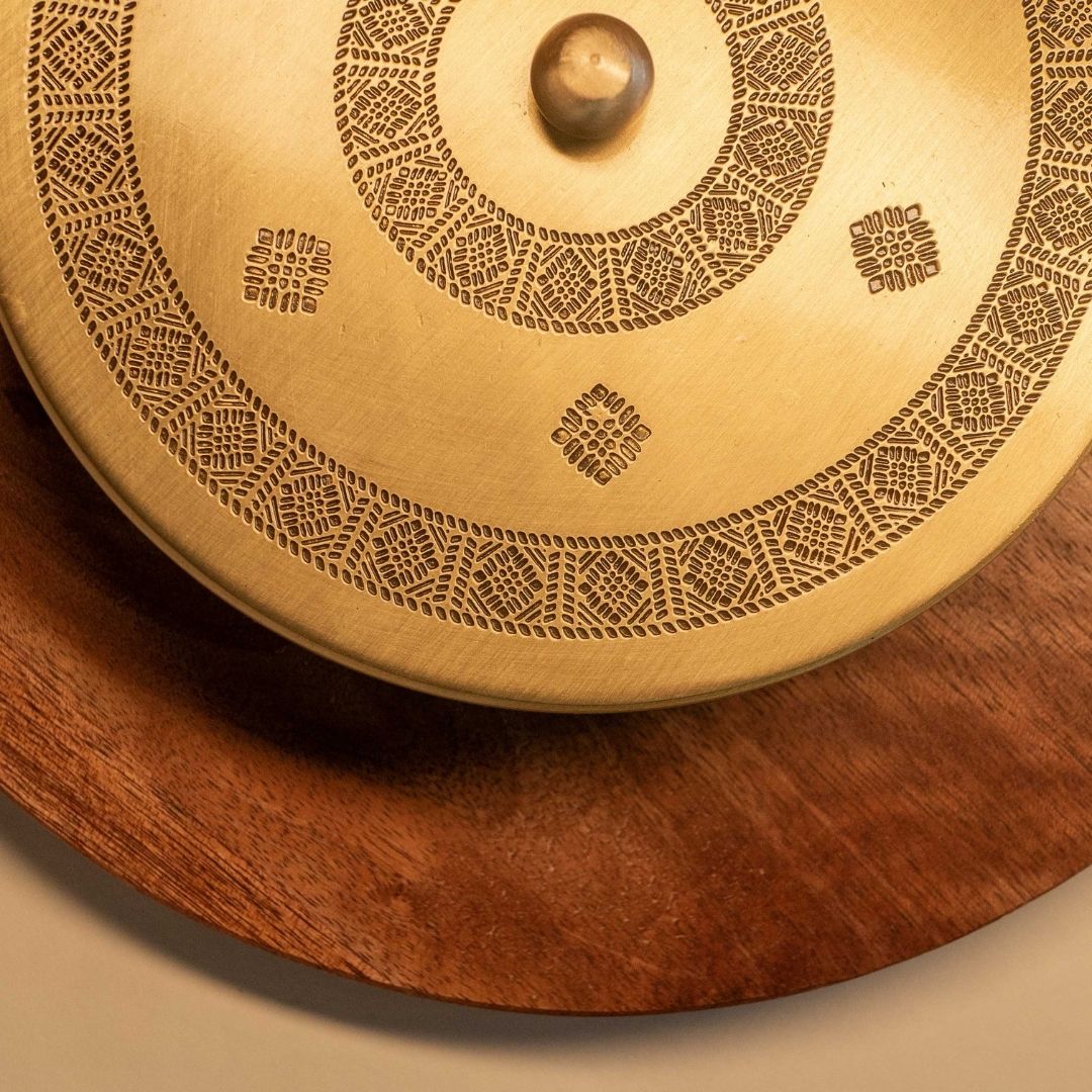 Handcrafted pure brass kitchen masala box with Kanjeevaram-inspired etching, adding timeless Indian elegance.