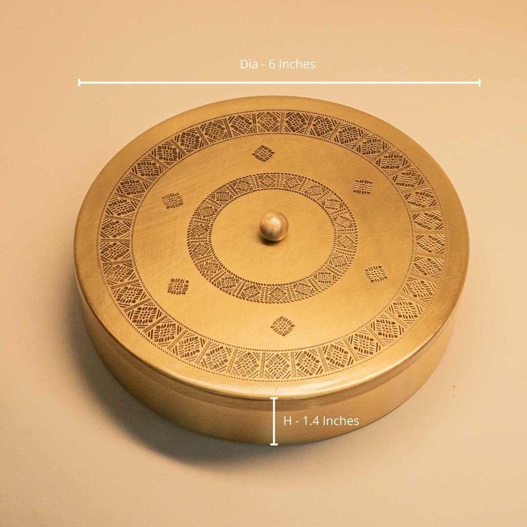Handcrafted pure brass kitchen masala box with Kanjeevaram-inspired etching, adding timeless Indian elegance.
