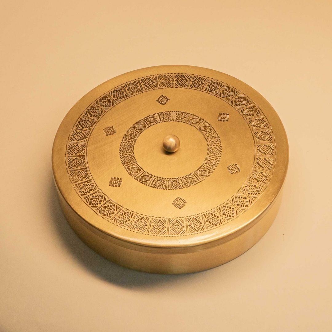 Handcrafted pure brass kitchen masala box with Kanjeevaram-inspired etching, adding timeless Indian elegance.