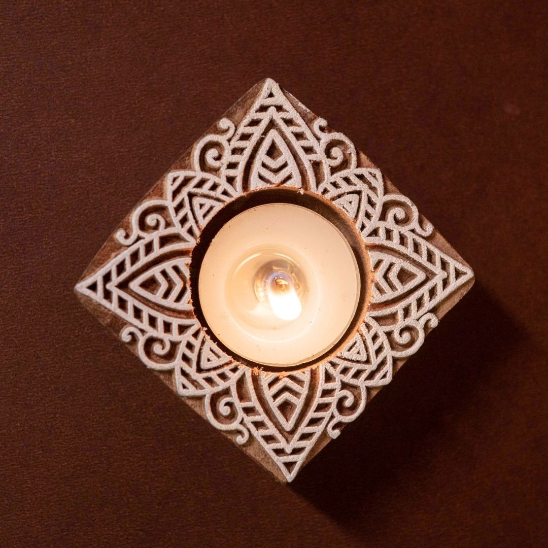 Hand-engraved mango wood diya set with tea lights in white and brown, set of 4, ideal for festive home décor and gifting.