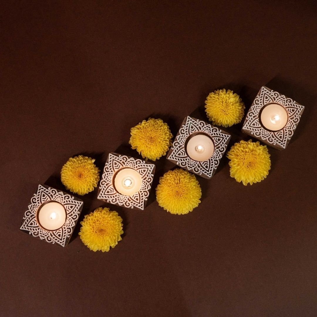 Hand-engraved mango wood diya set with tea lights in white and brown, set of 4, ideal for festive home décor and gifting.