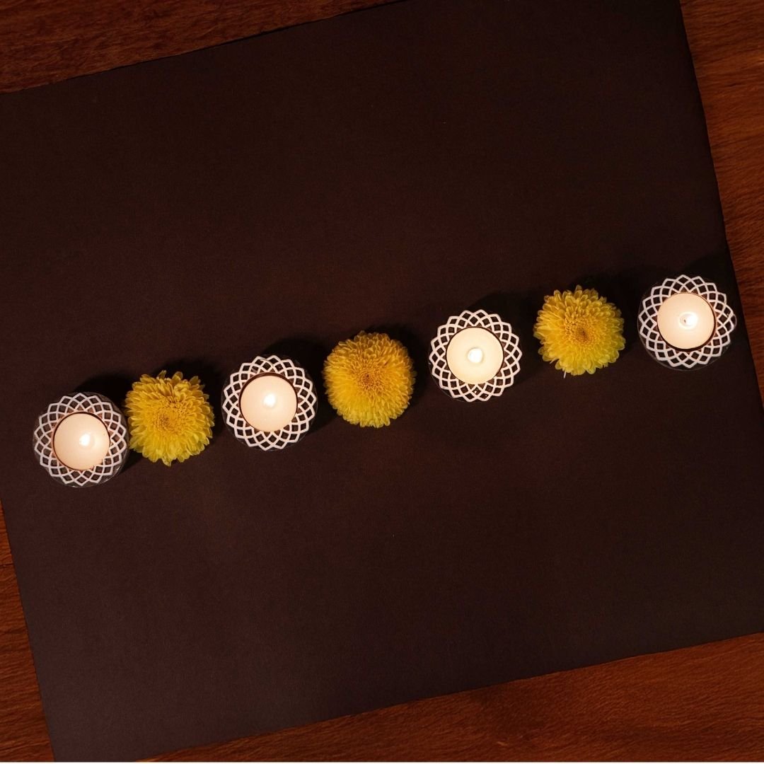 Hand-engraved mango wood diya set with tea lights in white and brown, set of 4, ideal for festive home décor and gifting.