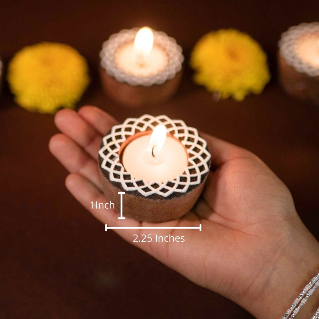 Hand-engraved mango wood diya set with tea lights in white and brown, set of 4, ideal for festive home décor and gifting.
