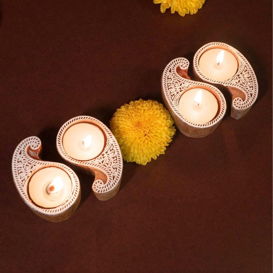 Hand-engraved mango wood diya set with tea lights in white and brown, set of 4, ideal for festive home décor and gifting.