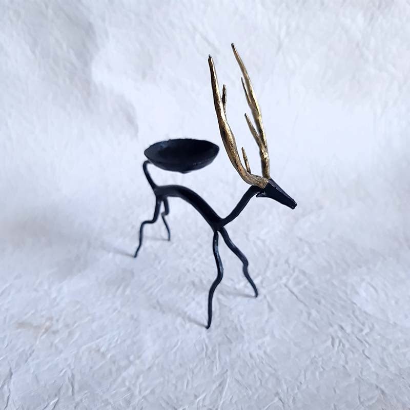Handcrafted Bastar wrought iron golden deer tealight holders. Set of 2 artisan pieces for warm, elegant home décor.