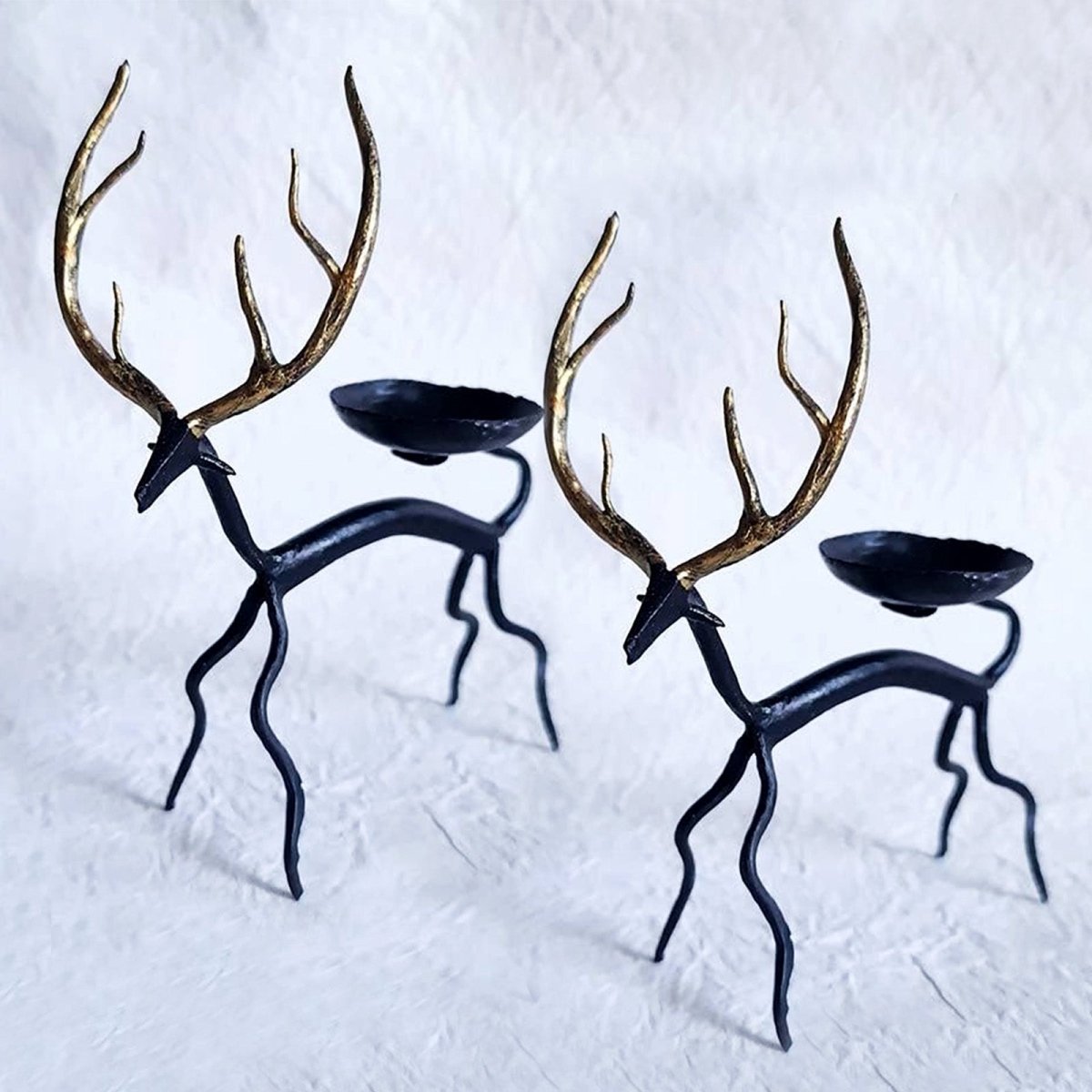 Handcrafted Bastar wrought iron golden deer tealight holders. Set of 2 artisan pieces for warm, elegant home décor.