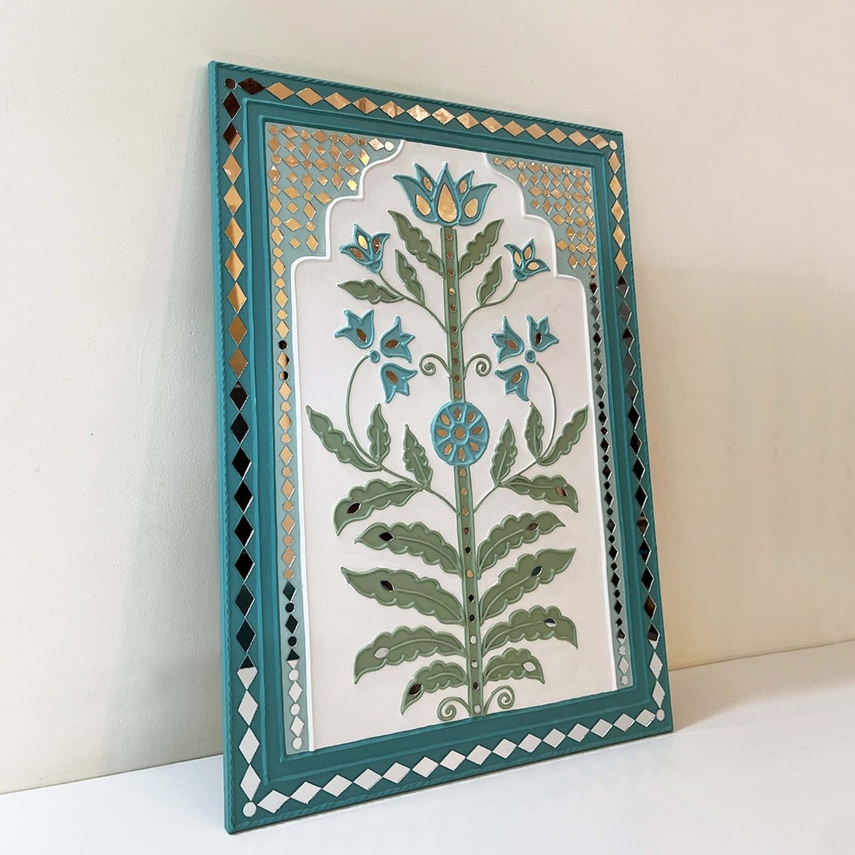 Handmade white & light green lippan wall hanging with mud and mirror work from Kutch.