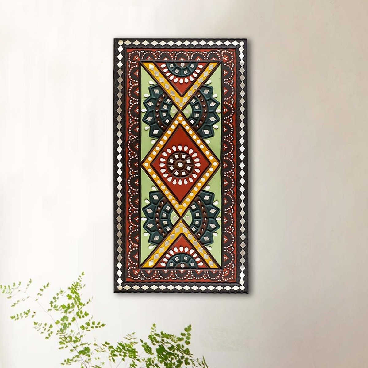 Green and brown handcrafted mud and mirror work wall art, adding a natural and earthy touch