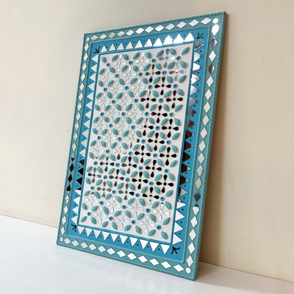 Handmade ocean blue Lippan wall hanging with mud and mirror work from Kutch.
