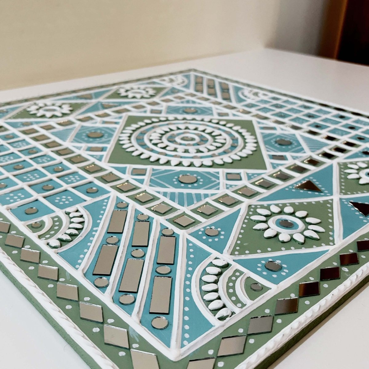 Handmade ocean blue sparkles lippan wall hanging with mud and mirror work from Kutch.